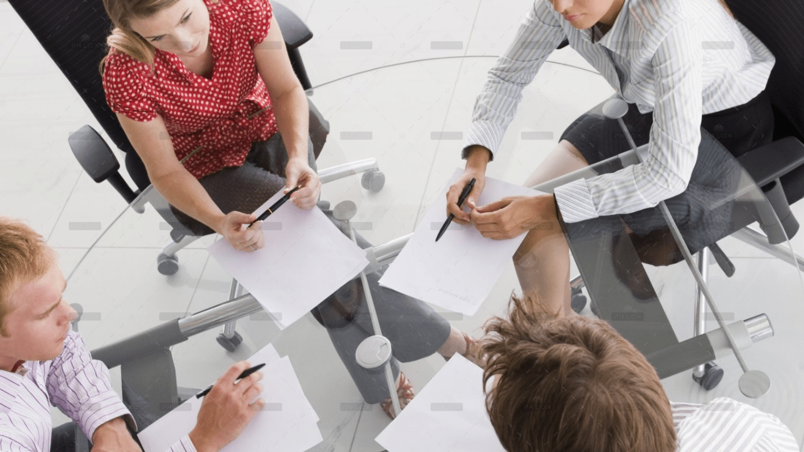 demo-attachment-1154-four-businesspeople-in-a-boardroom-with-paperwork-PC4V8H4@2x