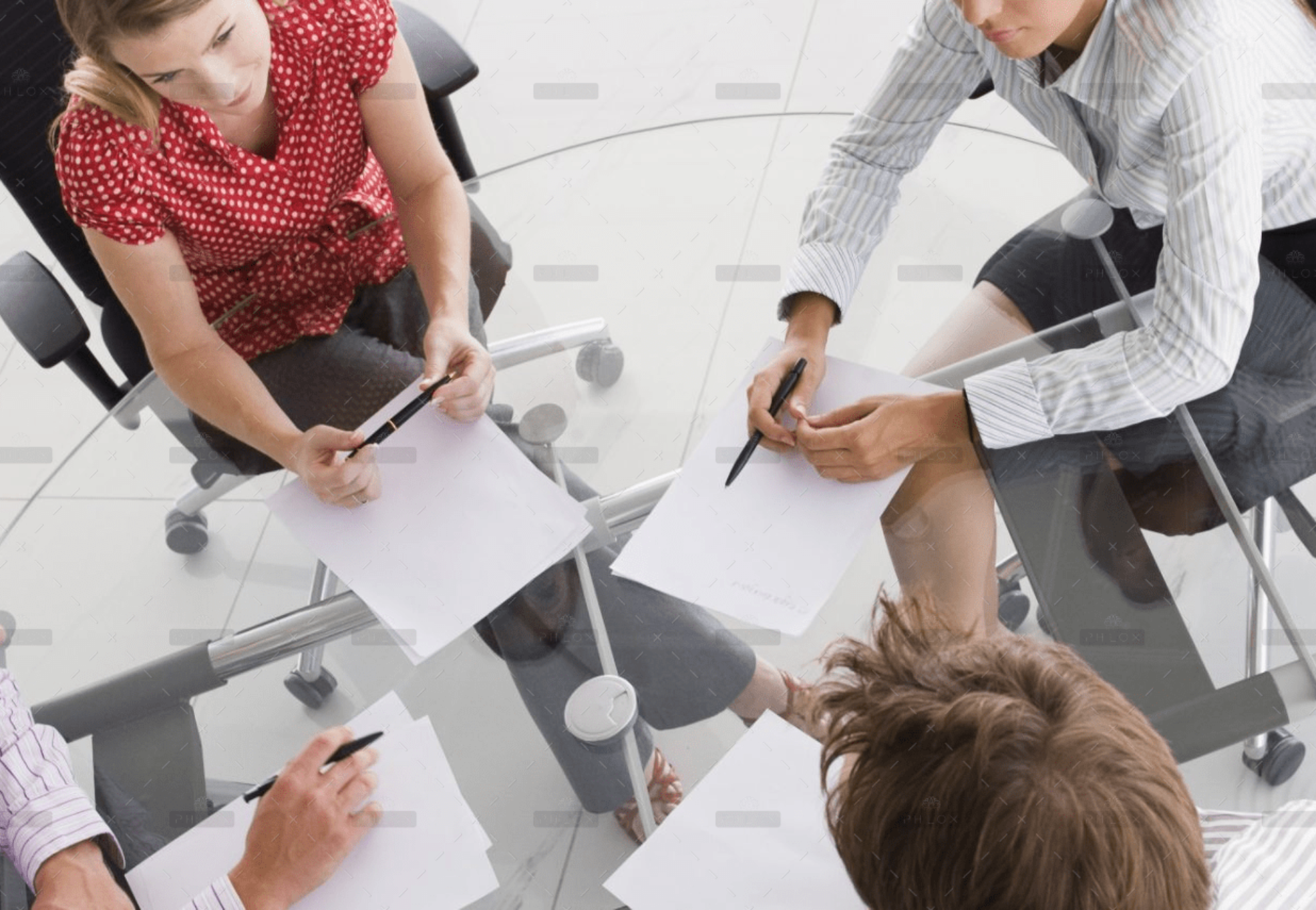 demo-attachment-1154-four-businesspeople-in-a-boardroom-with-paperwork-PC4V8H4@2x