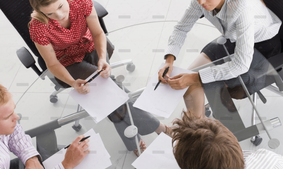 demo-attachment-1154-four-businesspeople-in-a-boardroom-with-paperwork-PC4V8H4@2x